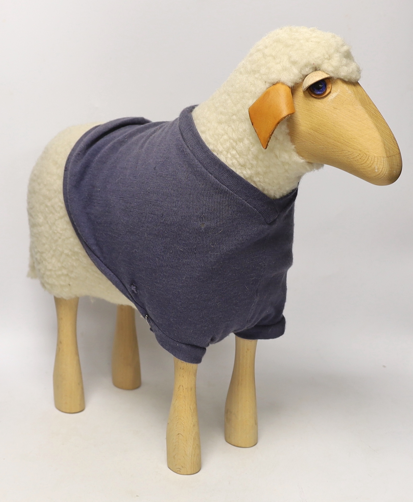 A Hanns-Peter Krafft sheep for Mayr Wool, beech body with wool and leather details, 46cm high